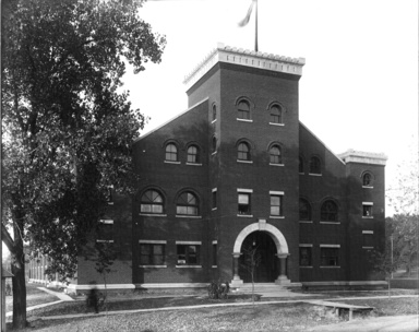 A black and white photograph of the Old Armory building from 1907